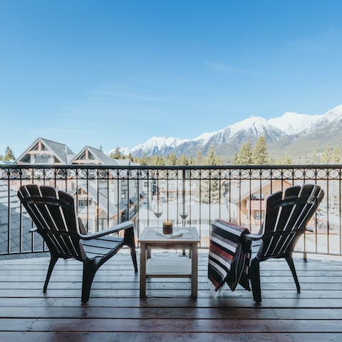 Take a seat on the balcony and watch the sun set behind the snow-capped mountains 