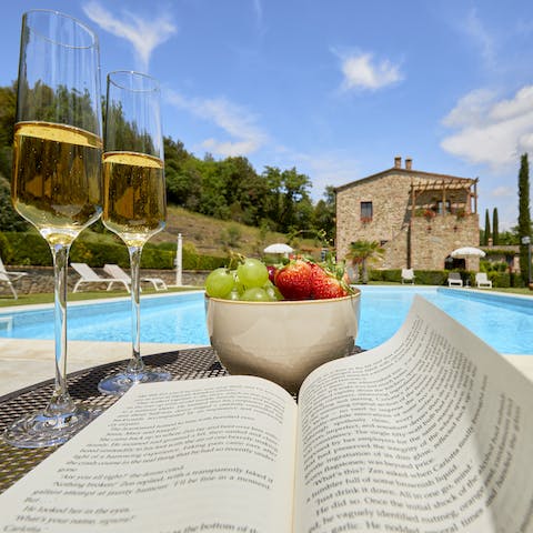 Put your feet up and relax by the inviting pool with a good book