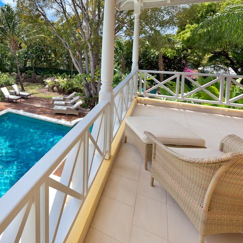 Enjoy the tropical views from the upstairs deck – the perfect spot to relax with a book