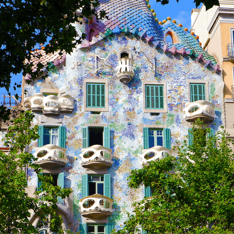 Admire the striking facade of Casa Batlló, an eight-minute walk from home