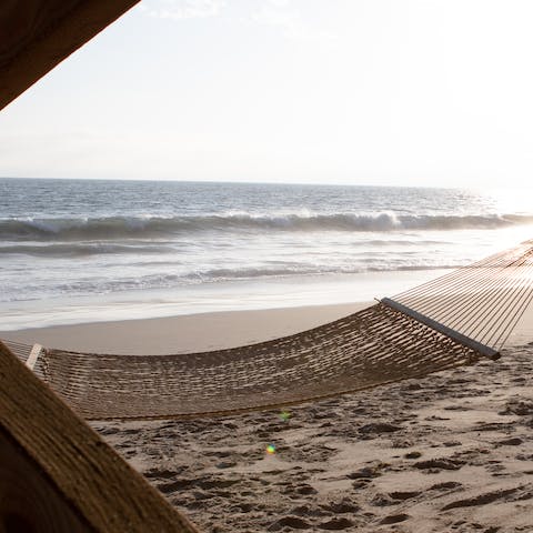 Head down to the shore and while away the day in the hammock