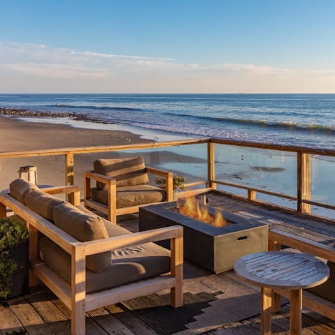Sip sundowners as you watch dolphins playing off the coast