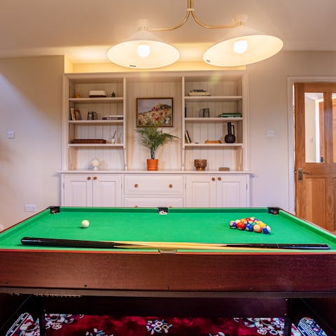 Get competitive over a round of pool in the cosy games room
