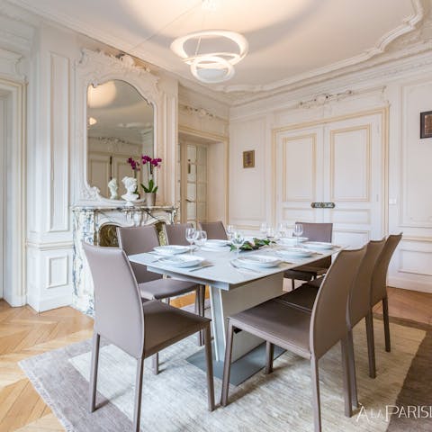 Gather in the opulent dining room by the marble fireplace