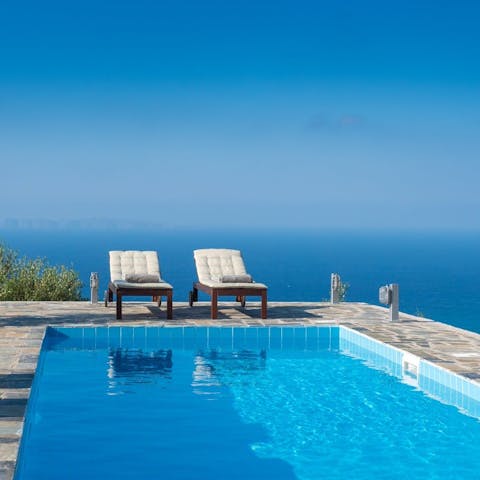 Soak up the sun on a poolside lounger overlooking the sea