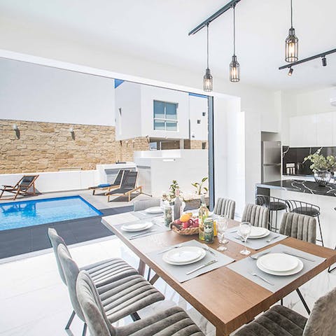 Open the sliding glass doors to merge indoor and outdoor living spaces – and keep an eye on the kids in the pool