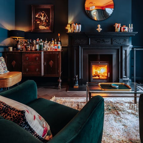Get cosy in front of the snug's fireplace, a glass of wine in hand