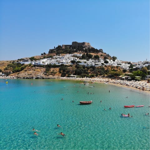 Drive up to the sunny Lindos, with its beautiful beaches and historical clifftop acropolis