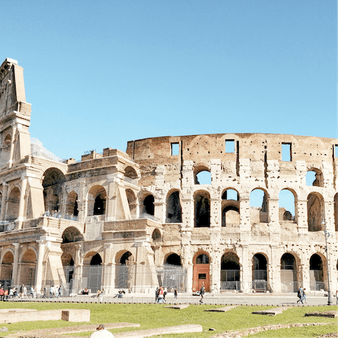 Gaze in awe at the mighty Colosseum, which can be reached in a thirty-minute walk from home