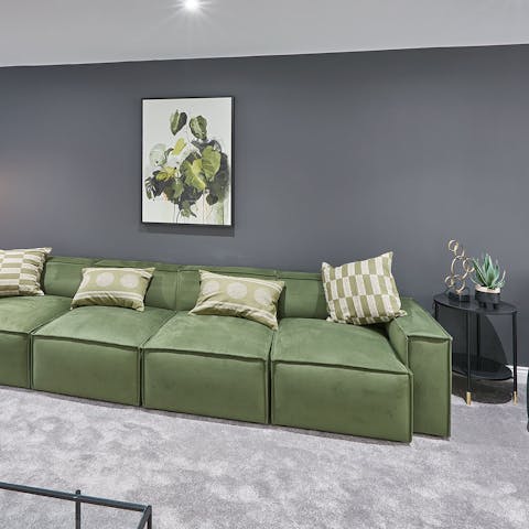 Open a bottle of your favourite wine and unwind on the comfy green sofa