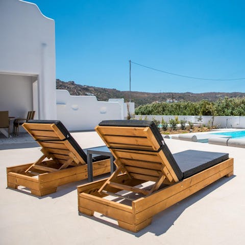 Grab a cold drink and enjoy the Greek weather from a sun lounger