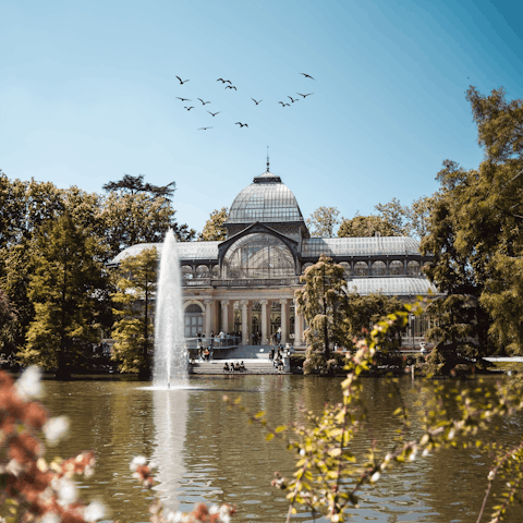 Stroll eighteen minutes to El Retiro Park to go boating on the lake
