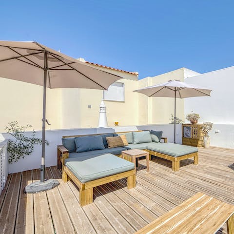 Soak up the sun on your private roof terrace complete with loungers and sun umbrellas