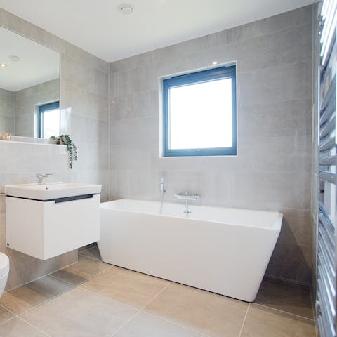 Feel relaxed without even visiting the spa in the home's boxy freestanding bathtub