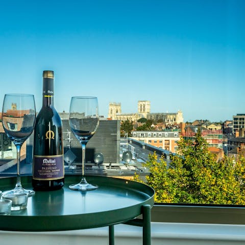 Sip a glass of wine while admiring stunning views of York Minster from the living room's floor to ceiling windows
