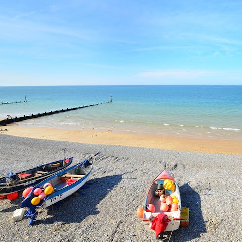 Sink your toes in the sand at Sheringham Beach, a fourteen-minute drive away