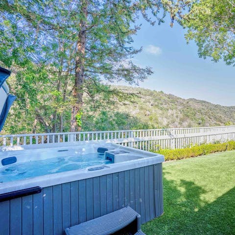 Slip into the private hot tub to relax after hiking
