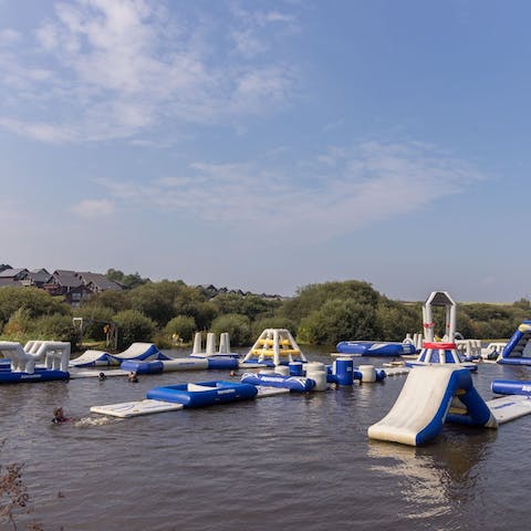 Try not to wipeout on the inflatable aqua park obstacle course