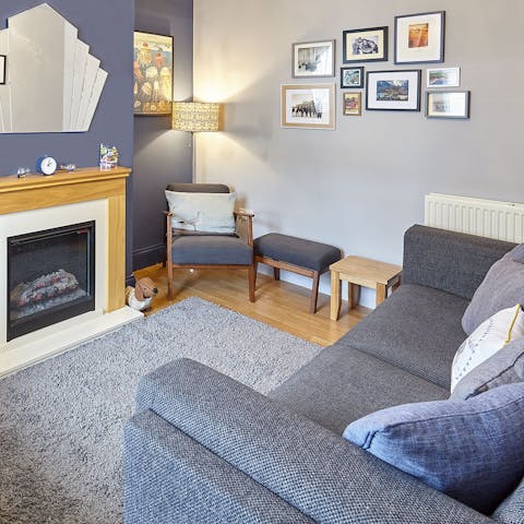 Get cosy by the fireplace and snuggle up on the comfy sofa