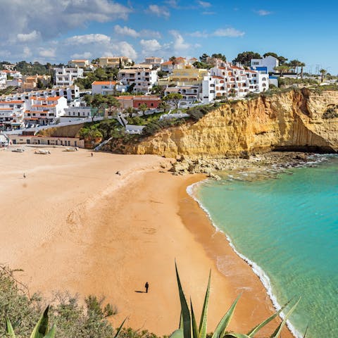 Enjoy the golden sands and crystal-clear seas of Carvoeiro beach, a short drive away