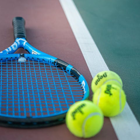 Hone your forehand on the home's private tennis court