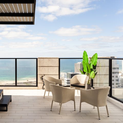Unwind in the midday sun as you enjoy a glass of wine on the balcony
