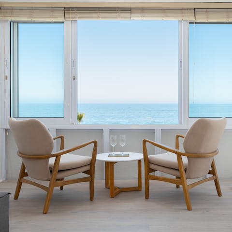 Gaze out at stunning ocean views from the sitting area in the lounge