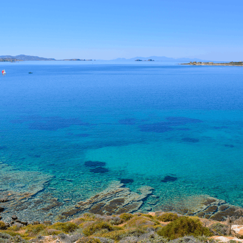 Explore the bright blue coast of Paros, starting with Megali Glastra, only minutes away on foot