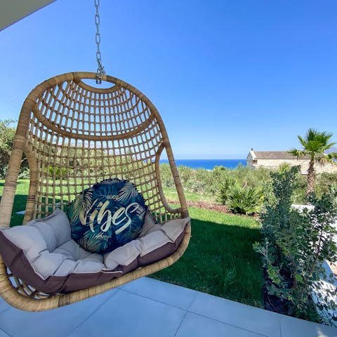 Grab a book and read in the nest chair as you overlook the sea