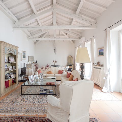 Take in the beauty of the vast living room with its vaulted beam ceilings