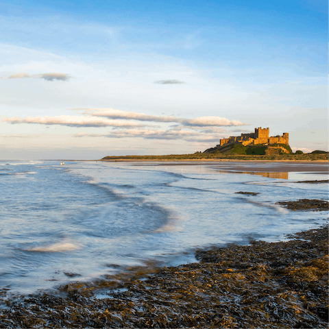 Drive six minutes to Bamburgh and visit the sandy beach and coastal castle