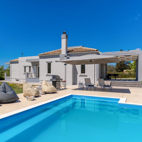 Splash about in the private pool and cool off from the Grecian sun