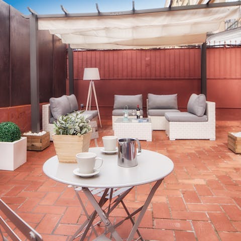 Seek shady solace underneath the pergola out on the apartment's terrace