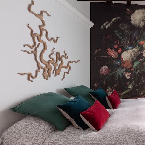 Nod off in the sumptuous bed, right next to bold wallpaper