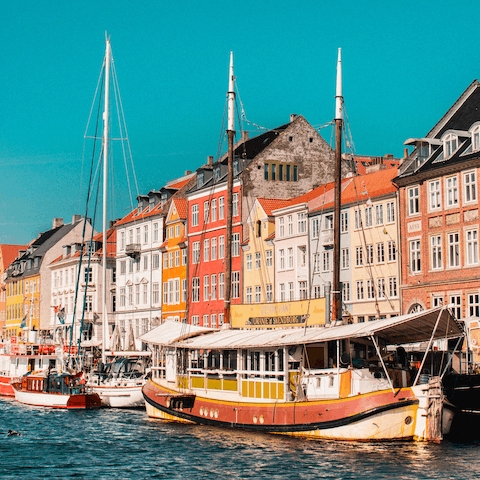 Sip a cold one as you people-watch outside one of the many restaurants in Nyhavn – ten minutes from your home