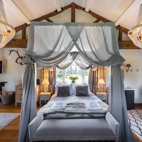 Enjoy sumptuous slumber beneath a canopy bed