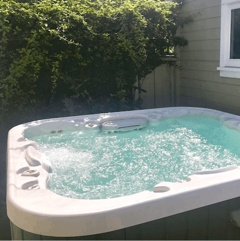 Unwind in the private hot tub after a busy day exploring your neighbourhood