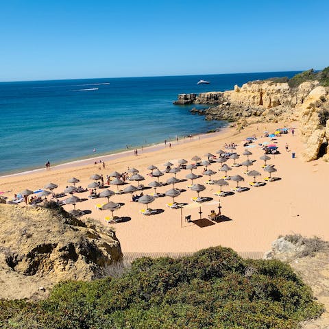 Enjoy a beach day at Praia de Albufeira – a ten-minute drive away