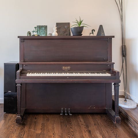 Tickle the ivories on the home's upright piano in the living room