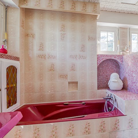 Indulge yourself with a long and uninterrupted soak in the red bathtub