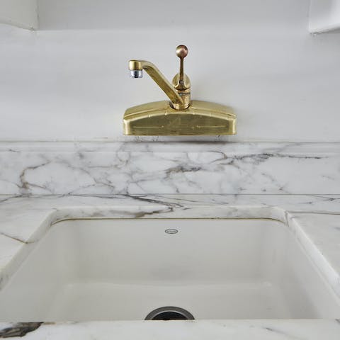 The marble and gold details in the bathroom