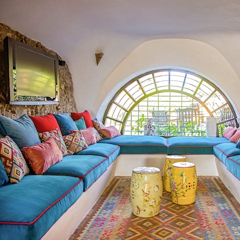 Cosy up as a group in the Moroccan-style TV room
