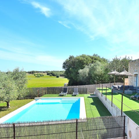 Take dip in this private pool and soak up some sunshine amid the stretching greenery