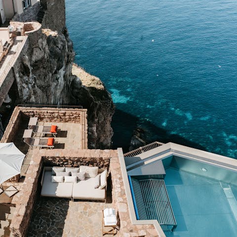 Swim in one of two infinity hydromassage pools 100m above the sea
