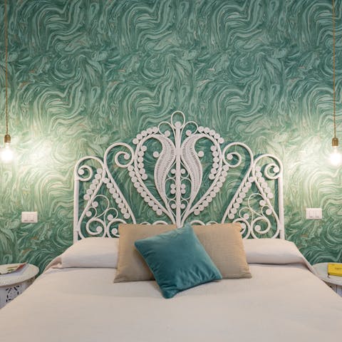 Enjoy a restful night and peaceful dreams thanks to the swirling statement wallpaper and comfortable bed