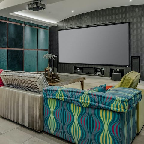 Curl up with your loved ones for a movie night in the cinema room