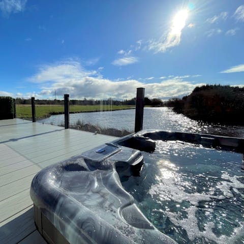 Watch the sun set over the water from the bubbles of the hot tub