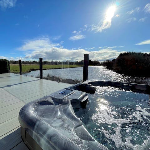 Watch the sun set over the water from the bubbles of the hot tub
