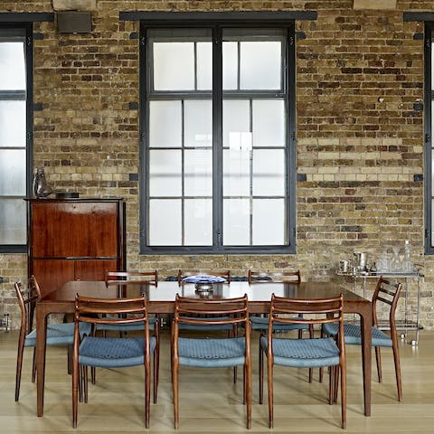 Gather together for a meal around the deep-walnut Danish table