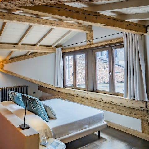 Wake up under the wood beamed ceilings, looking out onto St Mark's Square